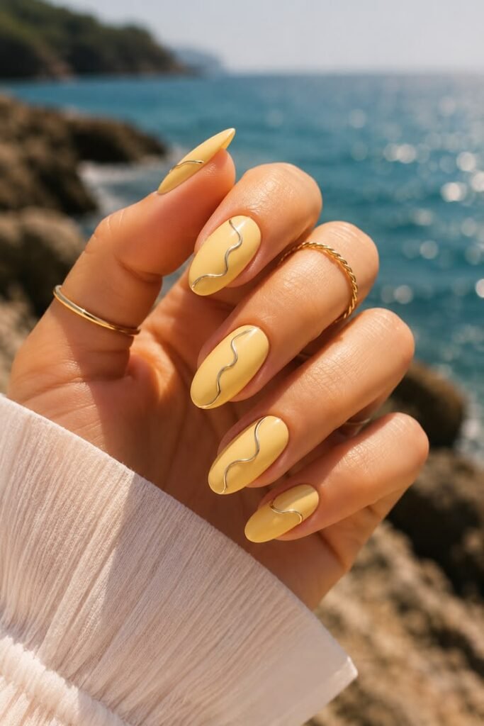 Sandy Yellow Almond Nails with Gold Chrome Waves